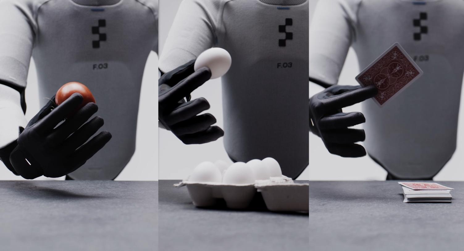 Three Figure 03 robot hands holding a tomato, an egg and a playing card